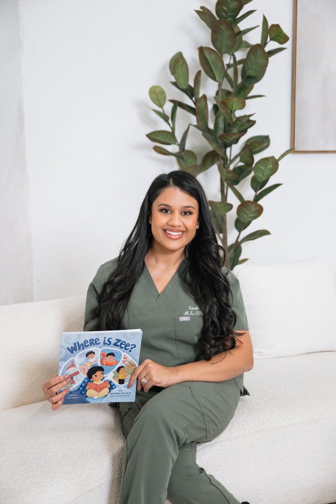 Sarah Bipath holding her children's book Where is Zee?
